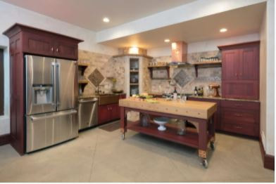 Kitchen with rosewood stain cabinets, white painted ceiling, and stone color backsplash
