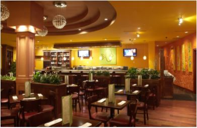 Painted restaurant with yellow ceiling, orange side walls and yellow walls at bar area